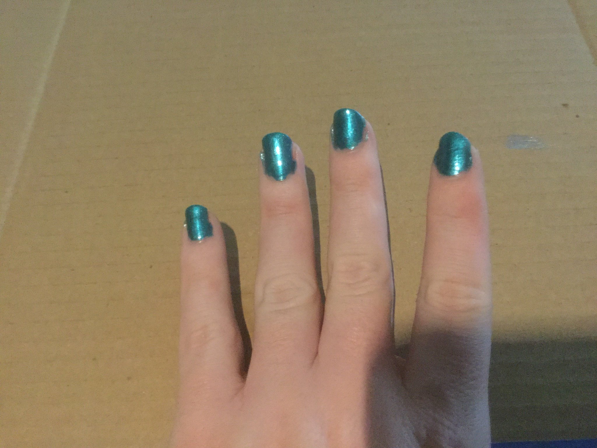 L.A. Colors “Island Dream”, a teal color with a fine glittery texture, subtler than “Mermaid”.